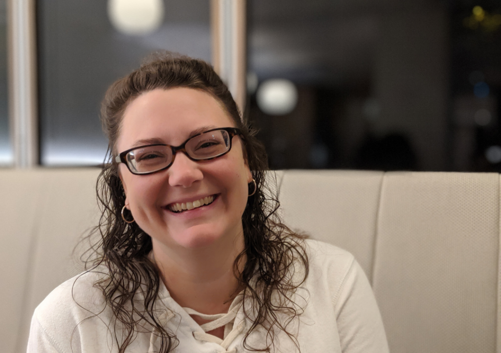 woman Emily Grabatin in white shirt smiling