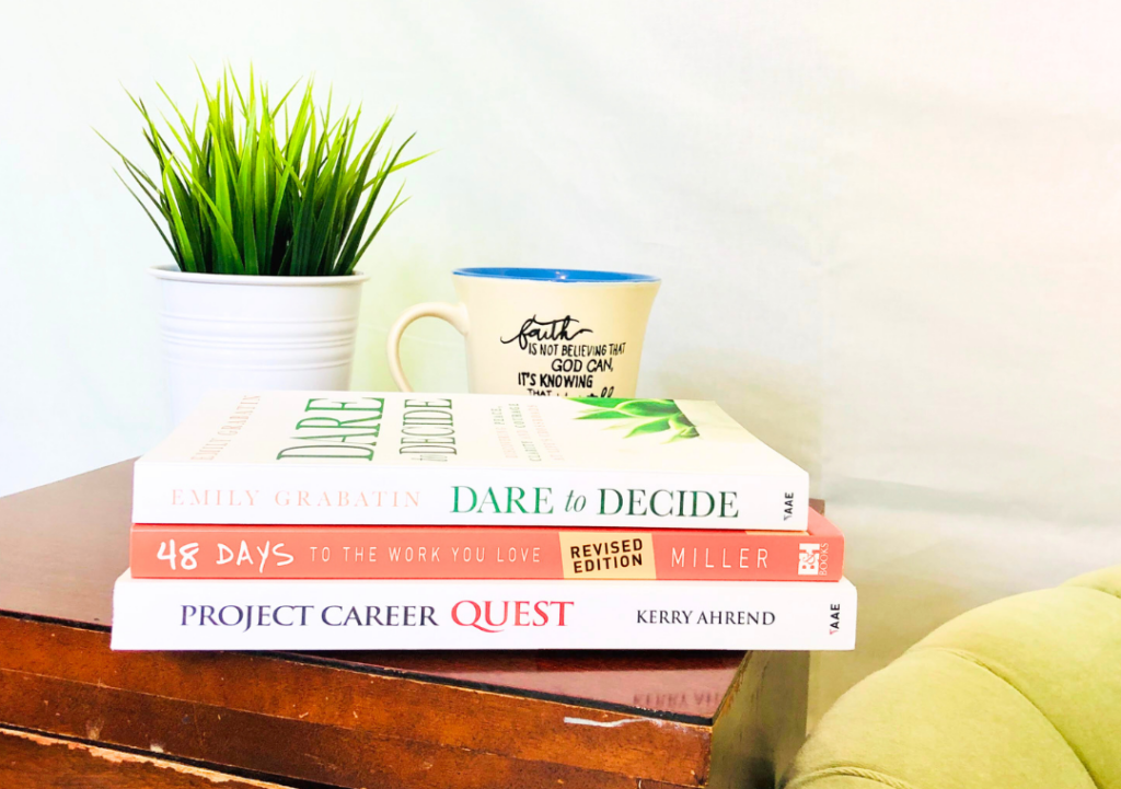 books about career change stacked on a side table, top title is Dare to Decide