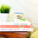 books about career change stacked on a side table, top title is Dare to Decide