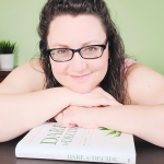 Emily Grabatin smiling over her book Dare to Decide